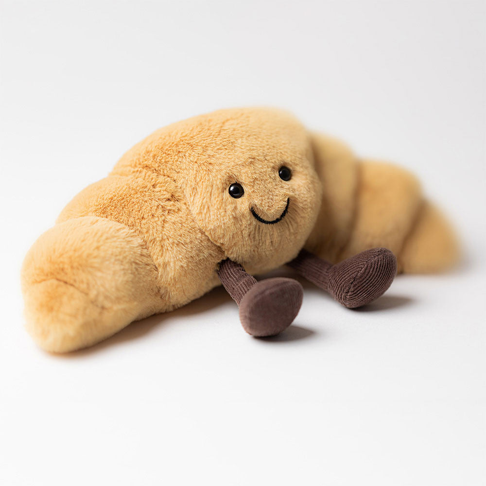 Jellycat Plüsch-Croissant 20 cm Kuscheltier mit braunen Füßen und freundlichem Gesicht