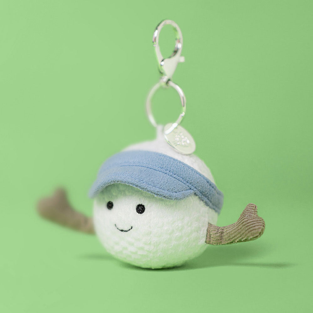 Jellycat Schlüsselanhänger fröhlicher Golfball 12 cm aus weichem Plüsch mit blauem Stirnband