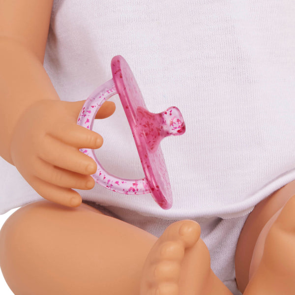 Babypuppe mit Schnuller im zweiteiligen Outfit mit Stirnband