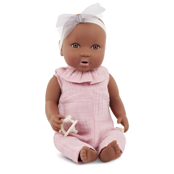 Babypuppe mit Schnuller im rosa Musselinoutfit mit Stirnband