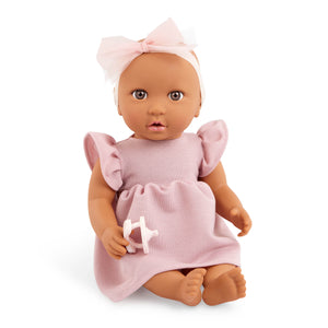 Babypuppe mit Schnuller im Kleid mit Stirnband