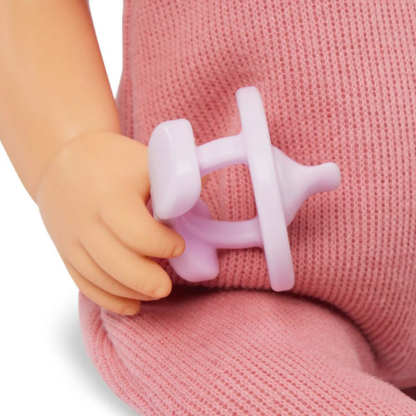 Baby-Puppe mit Schnuller, im Strampler und mit Stirnband