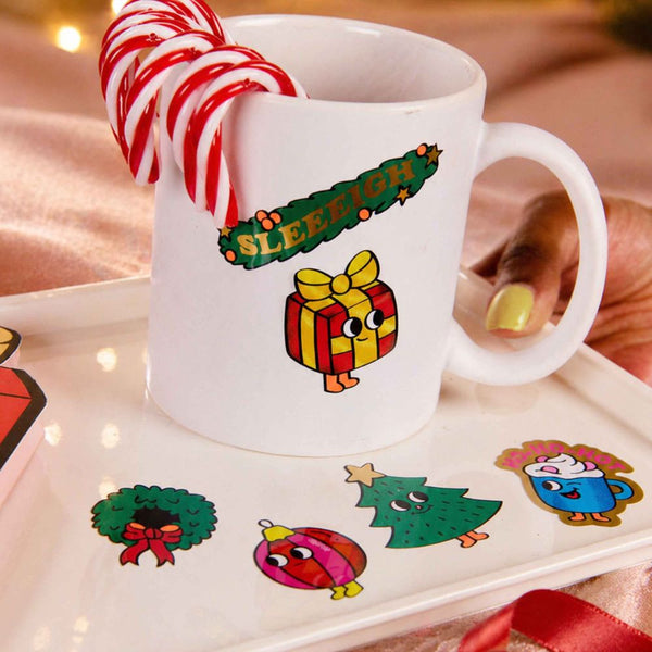 Tasse mit Weihnachtsstickern von OMY und Zuckerstange