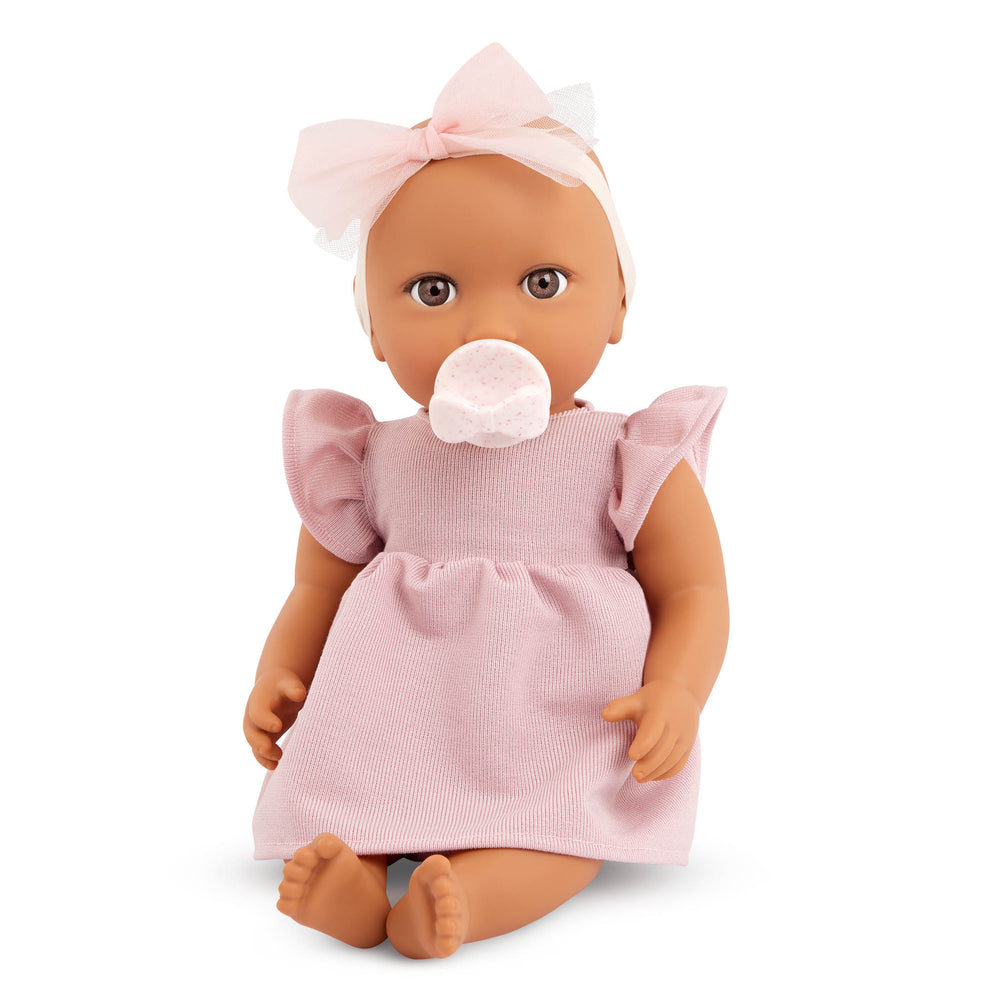 Babypuppe mit Schnuller im Kleid mit Stirnband